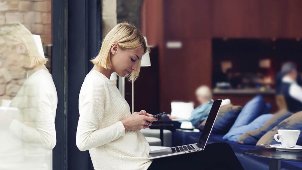 woman with phone and laptop