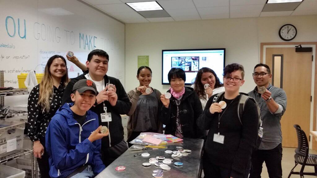 button making activity with multiple staff members