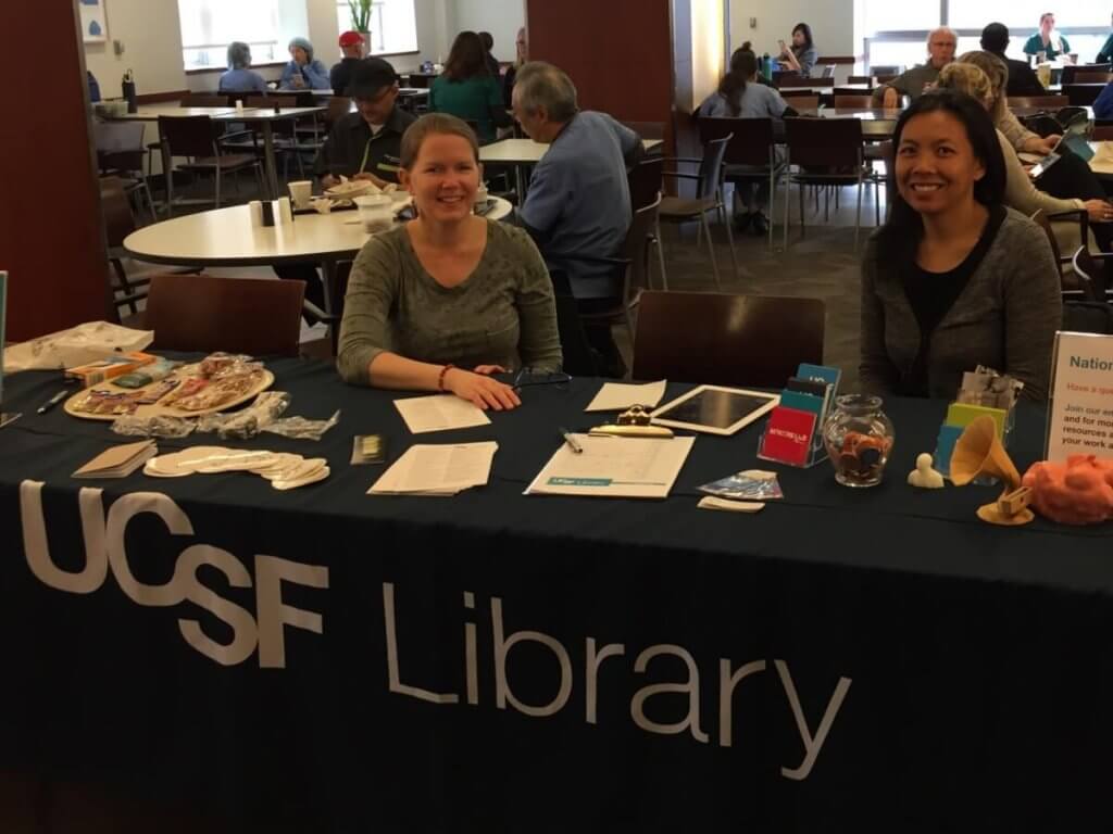 2 librarians at a table with handouts