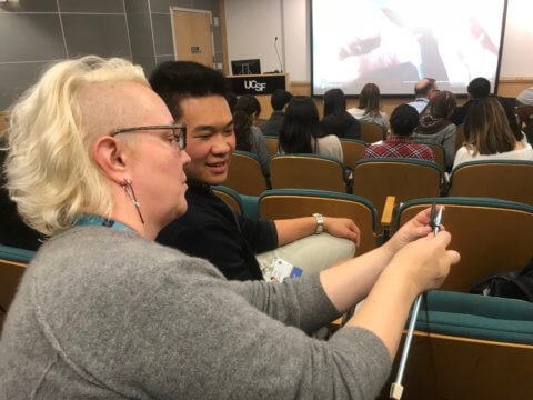 staff teaching student how to knit