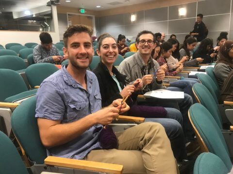 students learning how to knit