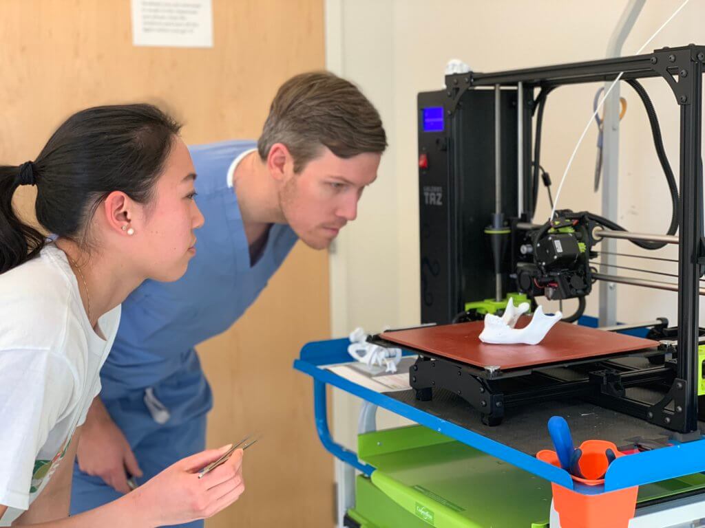 Derek and Stacey Dr. Harmon and Stacey Yu view a finished 3D printed mandible