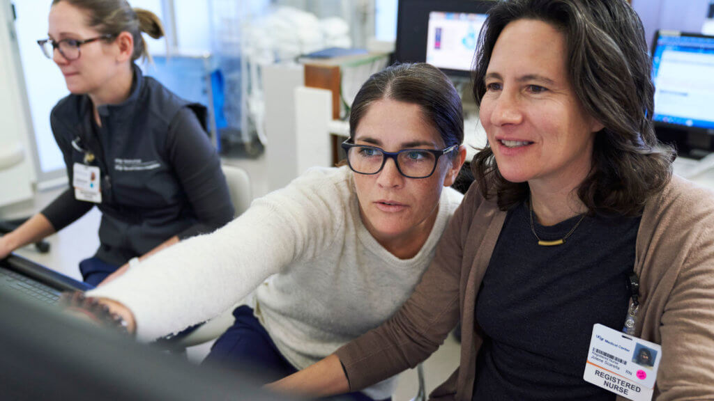 Two UCSF clinicians working together at a desktop computer