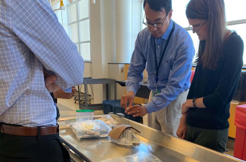 Faculty and residents practicing biopsy simulation using 3D printed models.
