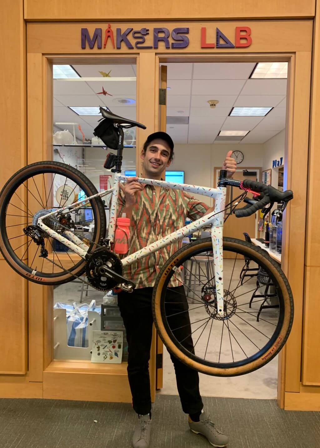 Angelo with bike outside of Makers Lab