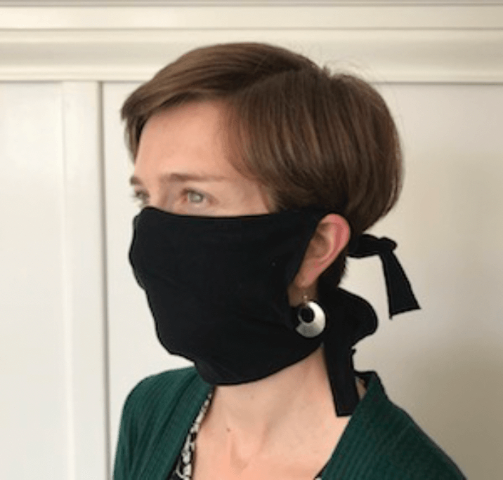 Staff member wearing hand sewn face mask.