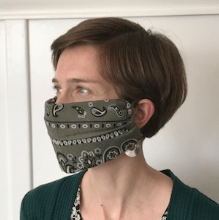 Staff member wearing hand sewn face mask.