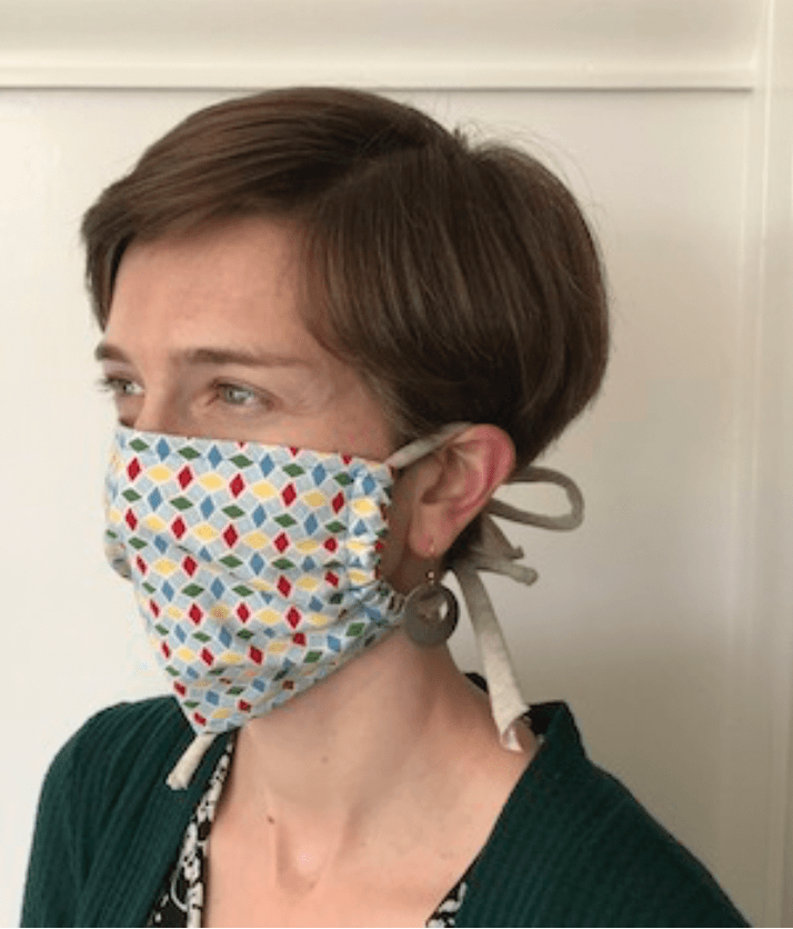 Staff member wearing hand sewn face mask.