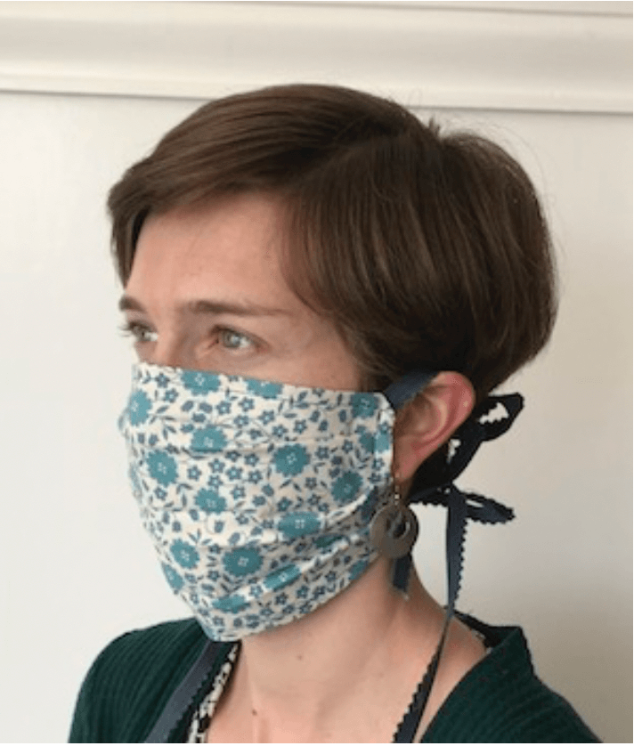 Staff member wearing hand sewn face mask.