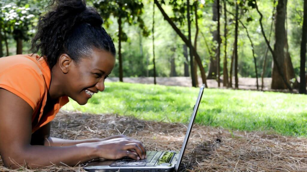 woman smiling at computer screen