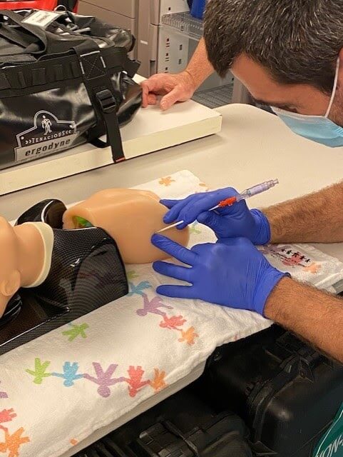 Doctor inserting tube into the neonatal simulation model