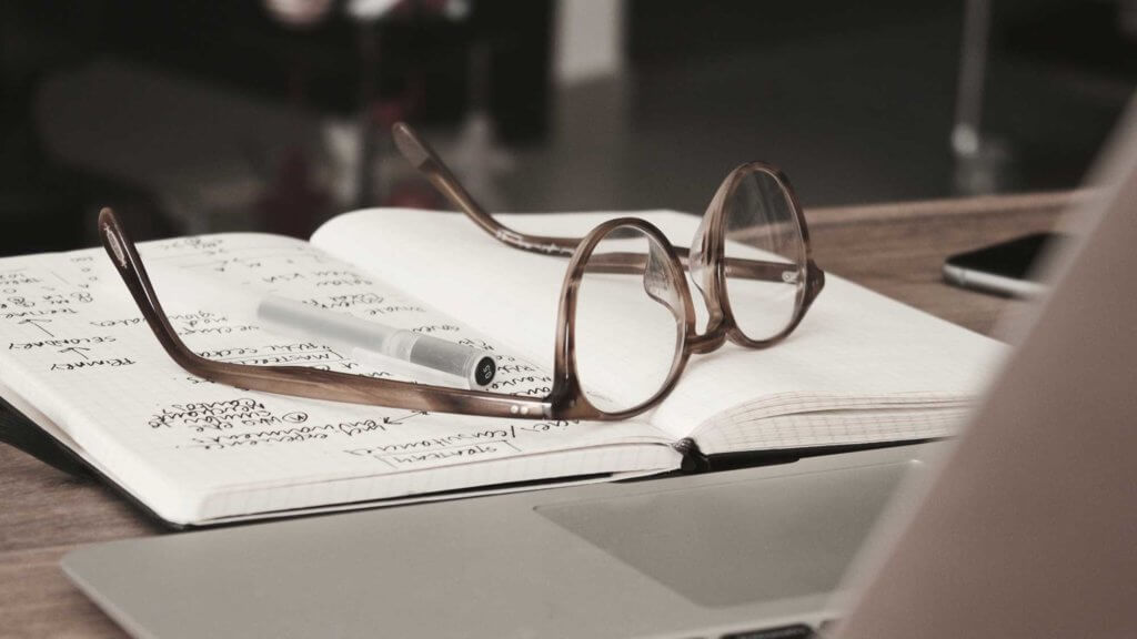 notebook and eyeglasses