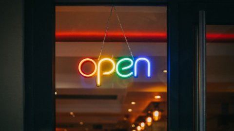 Neon sign reading "open" hanging in window