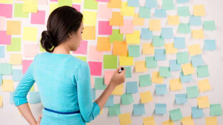 woman brainstorming with sticky notes