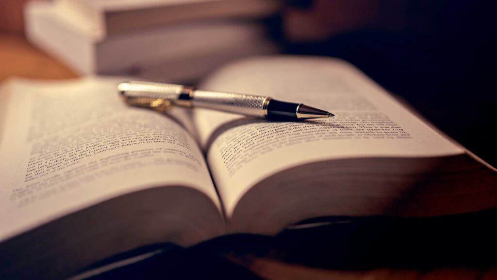 pen on an open book