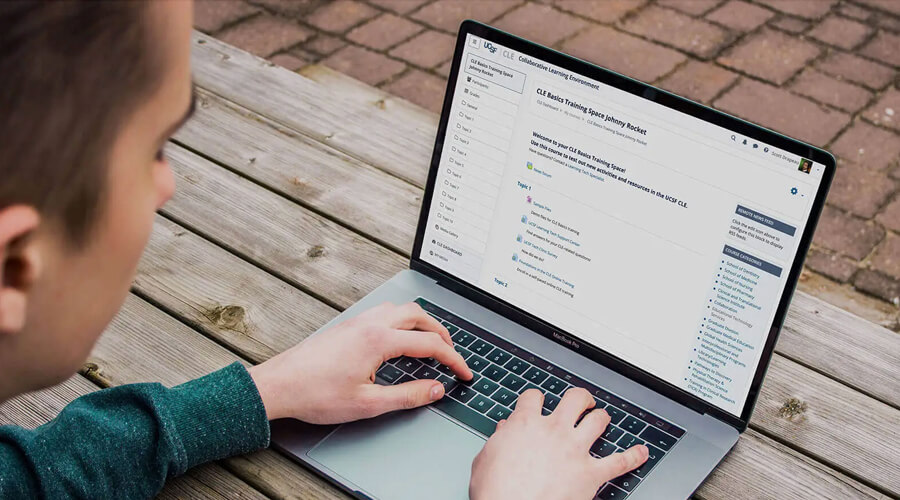 Person typing on a laptop computer.