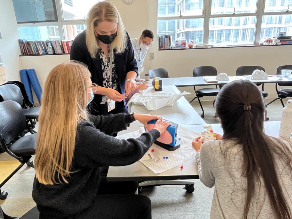 UCSF Hematology/Oncology fellows testing out the intrathecal chemotherapy simulation during orientation at the Anatomy Learning Center.