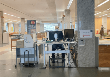 Access Services Supervisor, Eric Peterson, is sitting at the temporary Access Services Desk.