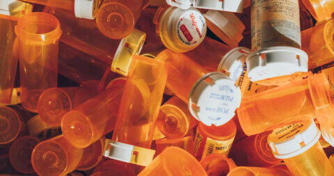 Empty orange prescription pill containers.