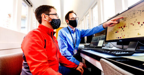 Two UCSF researchers looking at a computer screen and engaging in machine learning.