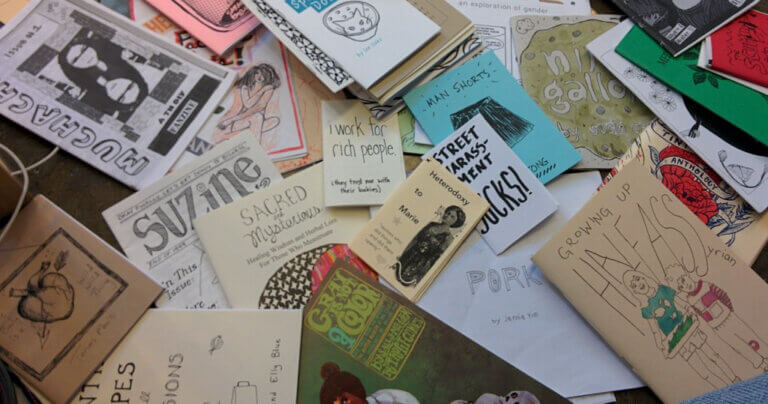 Zines scattered in a pile
