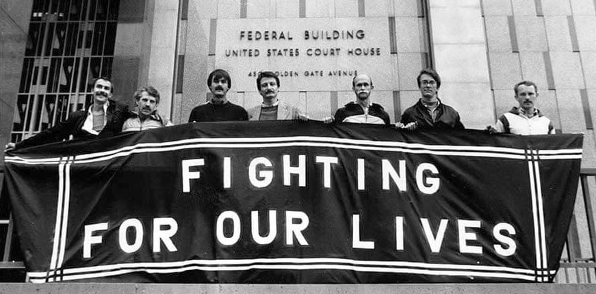 several men holding a fighting for our lives banner