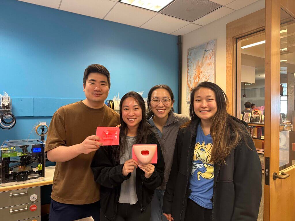 Caitlin Ye, Joany Xue, Selina Huang, and Honglip Park with 3d printed dental model in Makers Lab