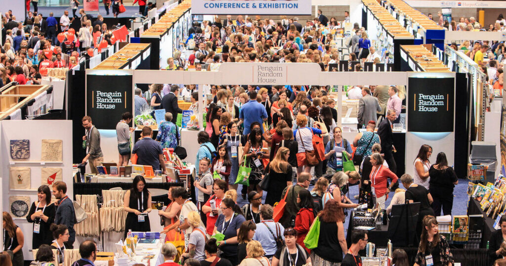 A large crowd of people in an exhibition hall at the ALA Conference