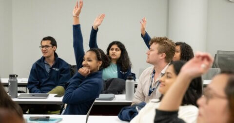 Global Health Sciences students raising their hands