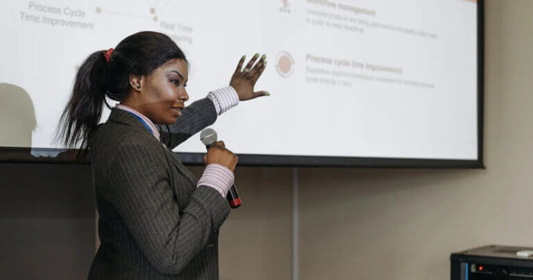 Woman with a microphone giving a presentation