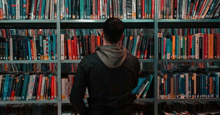 Man perusing bookshelf