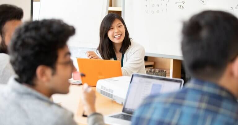 UCSF graduate student meeting with undergraduates at a conference table.