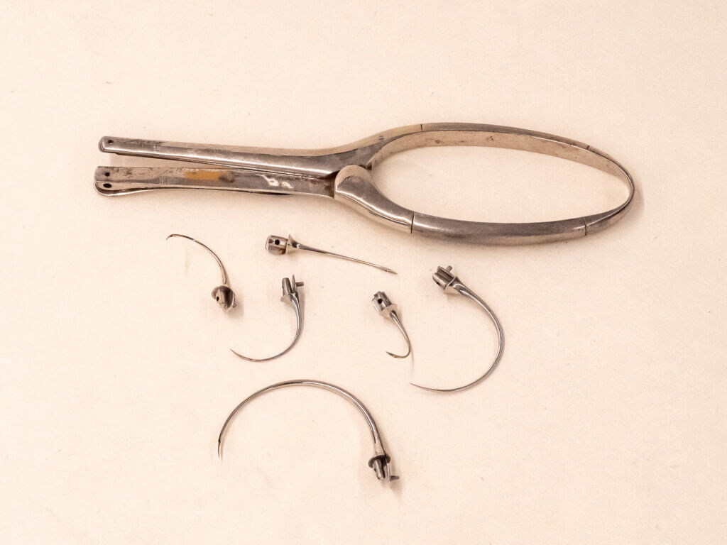 Suture kit with curved needles with needle clamp