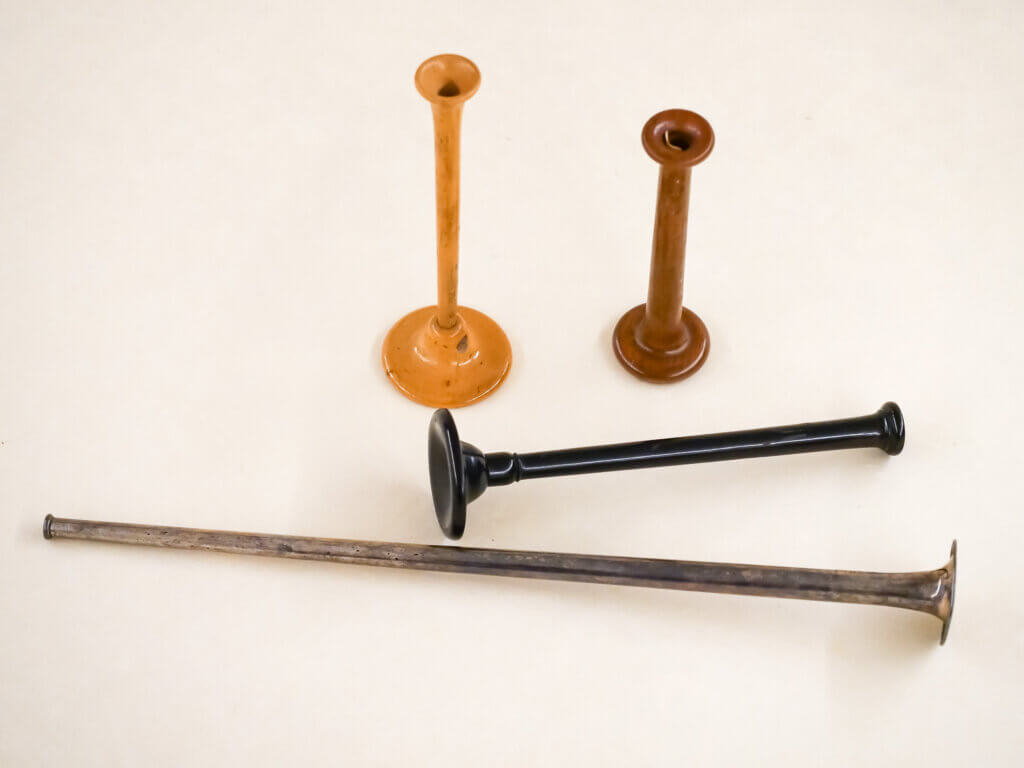 Metal stethoscope and three wood stethoscopes