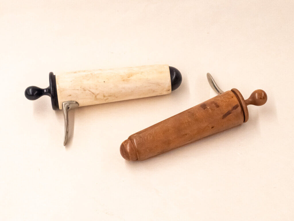 Two vaginal specula, made of ivory and wood
