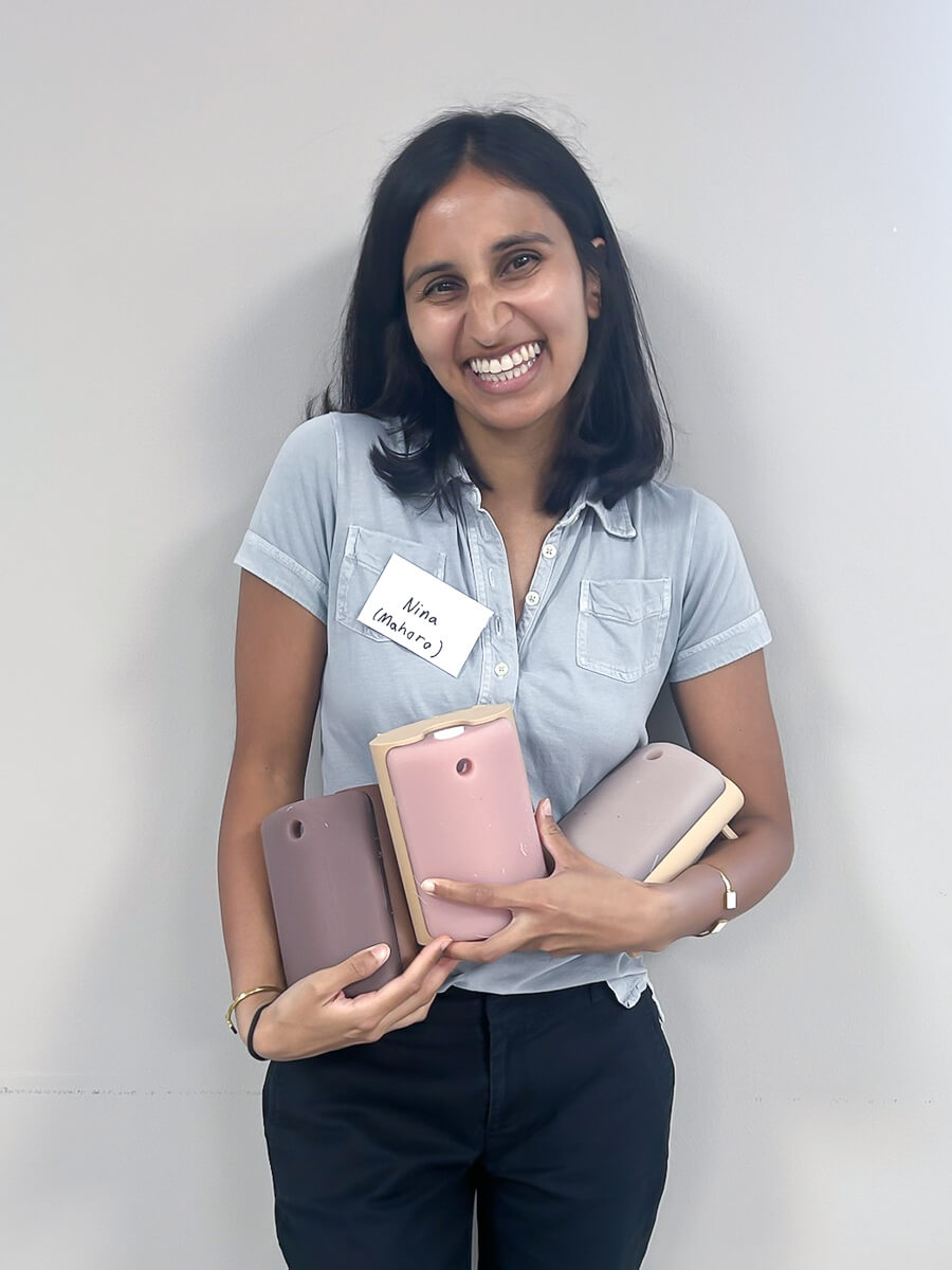 UCSF research fellow Nina Patel standing and holding with 3D printed tracheostomy models.