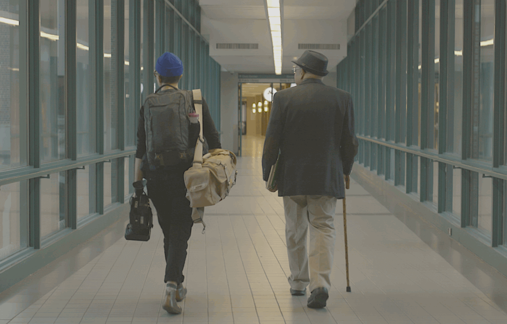 Michelle walking with Brother John-Richard Pagan in a hallway in the Mayo Clinic.