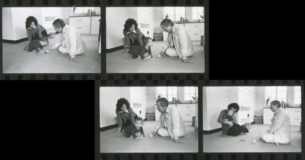 Four frames of a black and white film strip showing Selma Fraiberg interacting on the floor with a mother and her toddler.