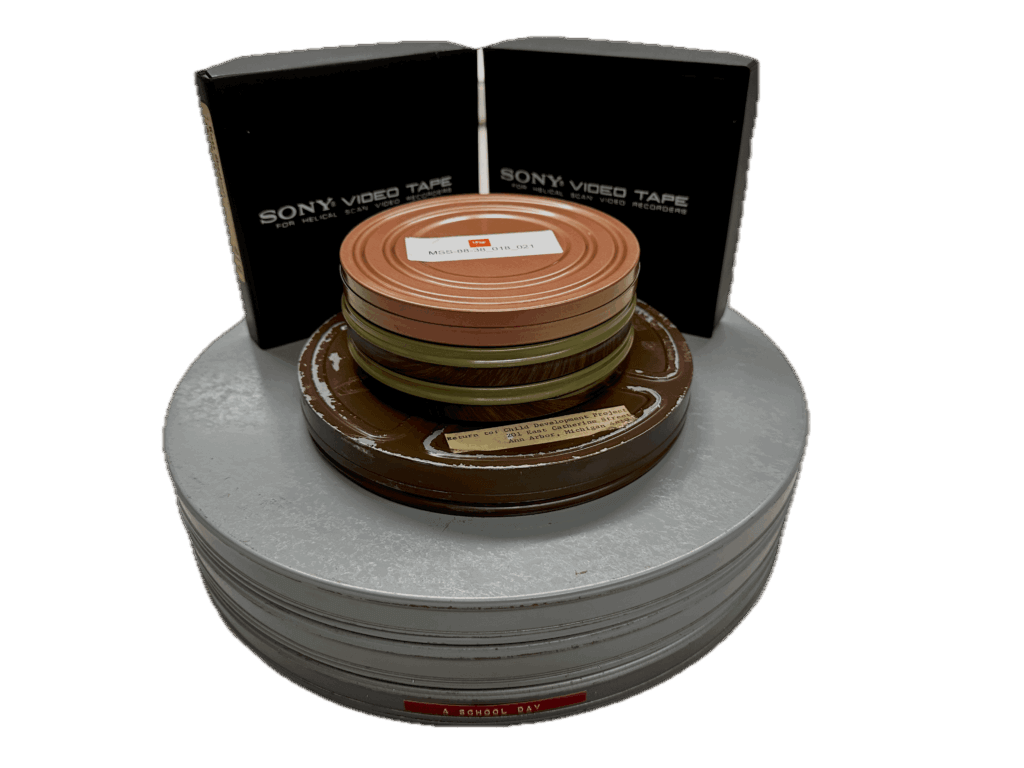 Film cans and half-inch video tapes from the Selma Fraiberg Film Collection.