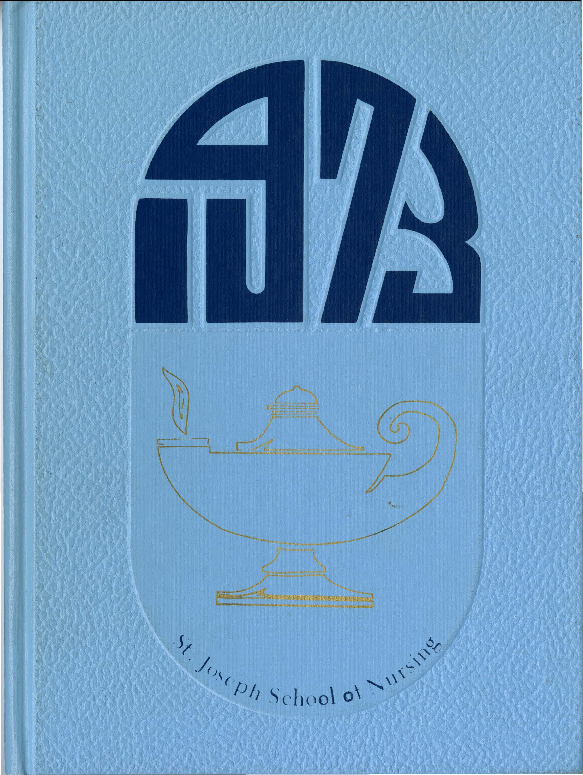 Blue book cover with the number 1973, an oil lamp, and the title St. Joseph School of Nursing