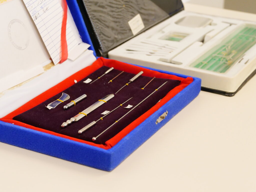 Two traditional Chinese medicine acupuncture sets open and on a table.