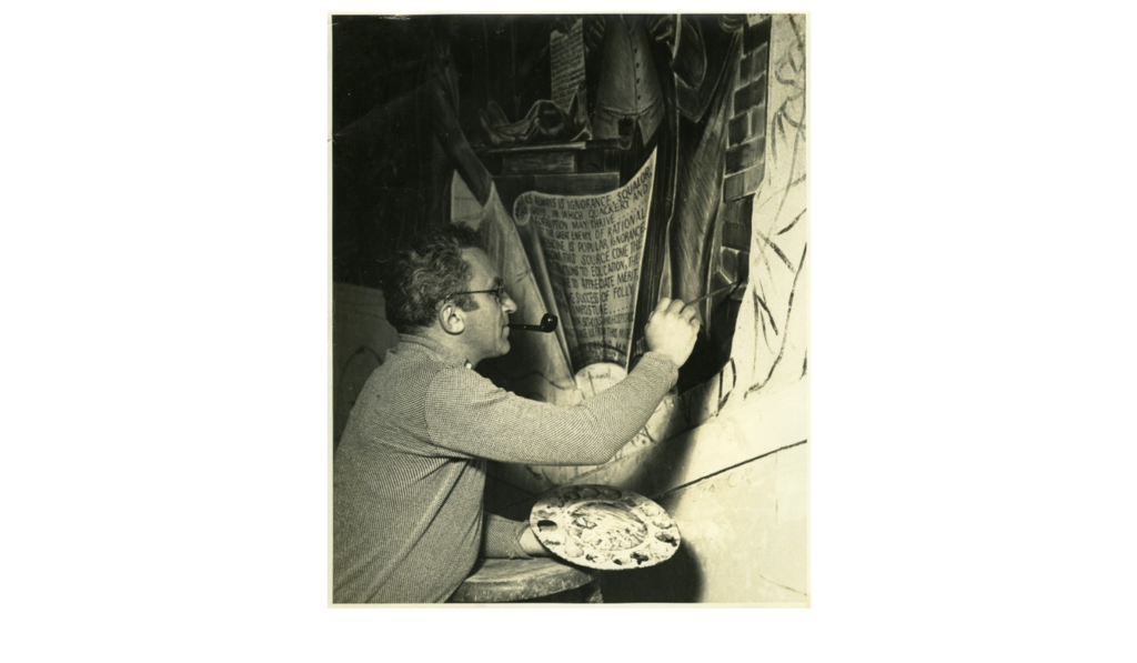Bernard Zakheim painting a mural at UCSF Toland Hall, with his right hand, in his left hand is a paint pallet and a tobacco pipe is in his mouth.