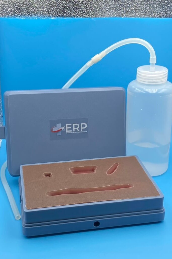 bleed-control model made of beige silicon with liquid bottle and tube and ERP gray case.