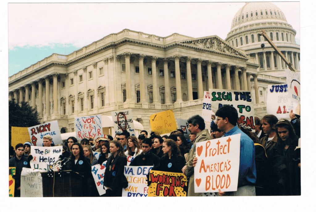 A crowd of mostly young people rallying by the United States Capitol and holding signs with slogans like "Protect America's Blood" and "Vote 4 Ricky Ray Help Heal."