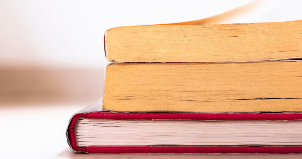 The tops of three books stacked on one another.