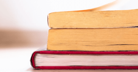 The tops of three books stacked on one another.