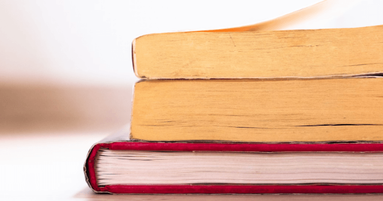 The tops of three books stacked on one another.