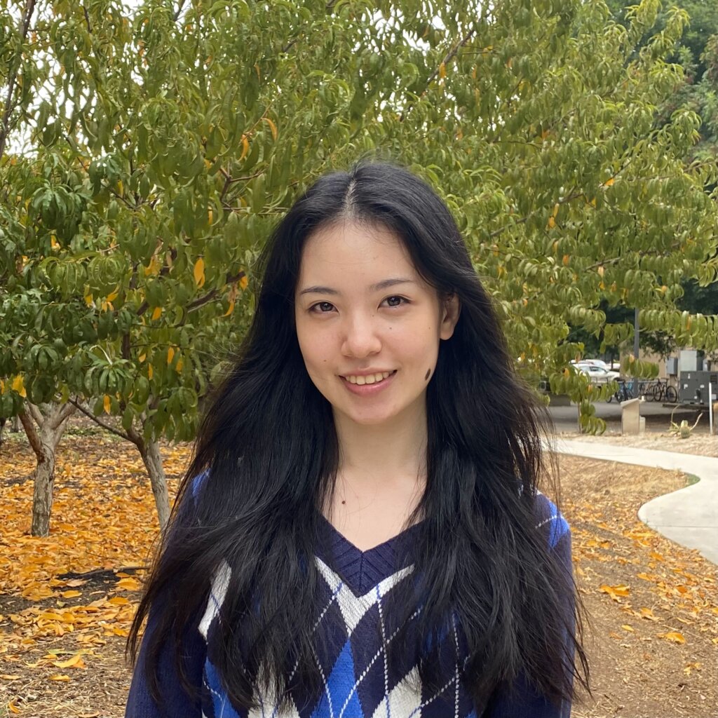 Muyun Tsen outdoors and smiling.